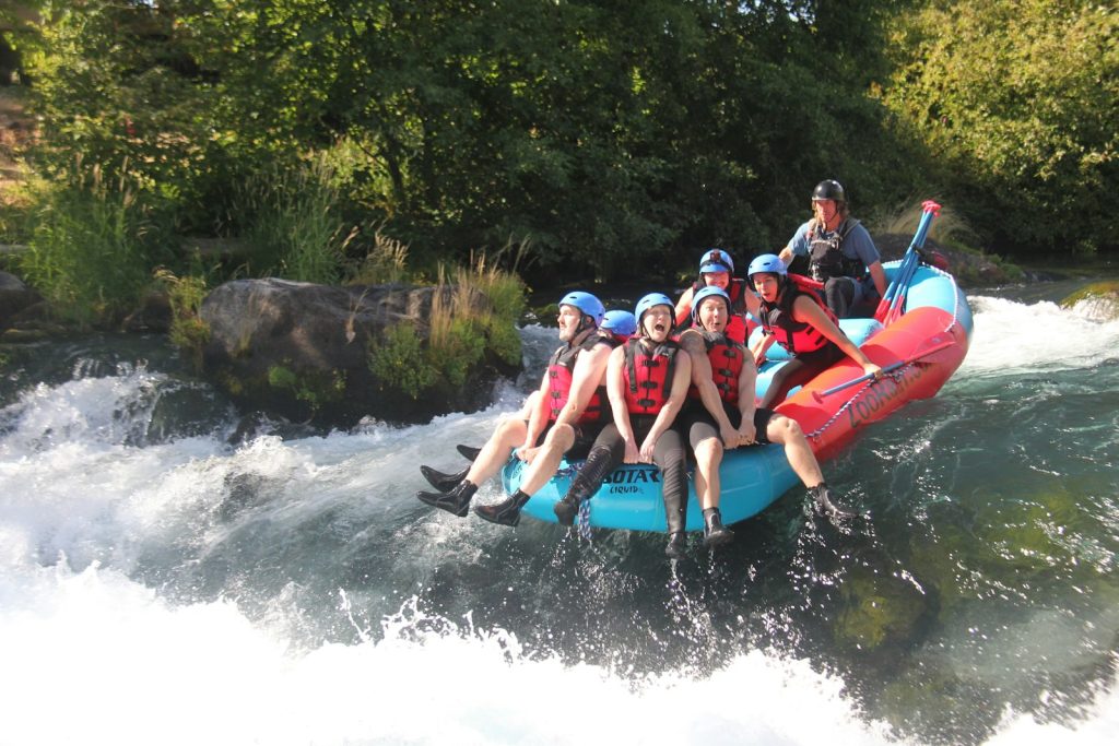 Group white water rafting down a river